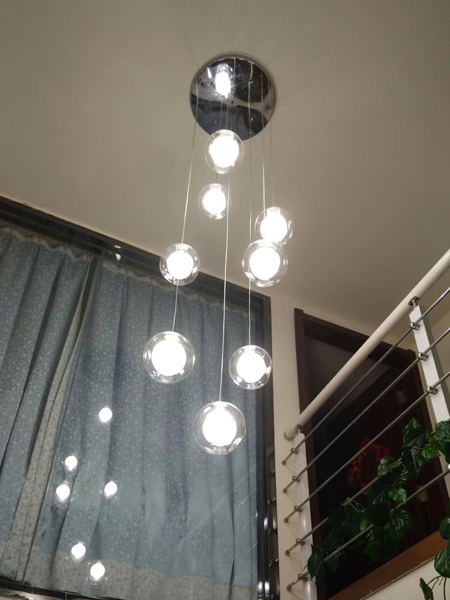 Clear globe lights descending by dark curtain