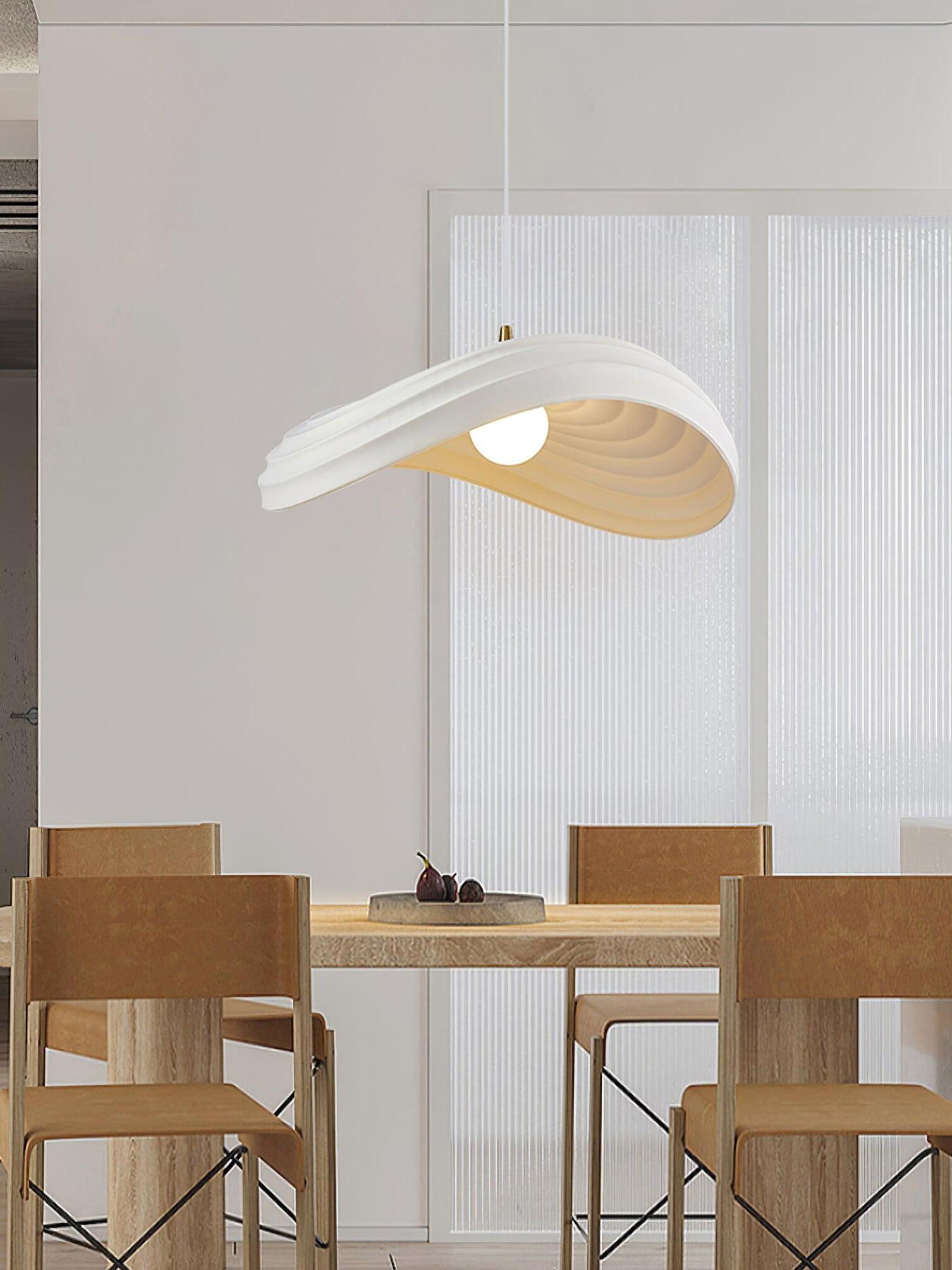 White cutout pendant over wooden dining table, wide view