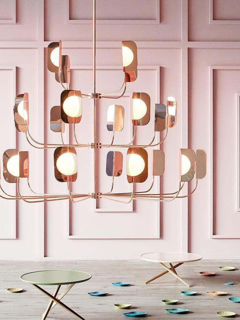 Leaf-shield chandelier above a pink dining setting