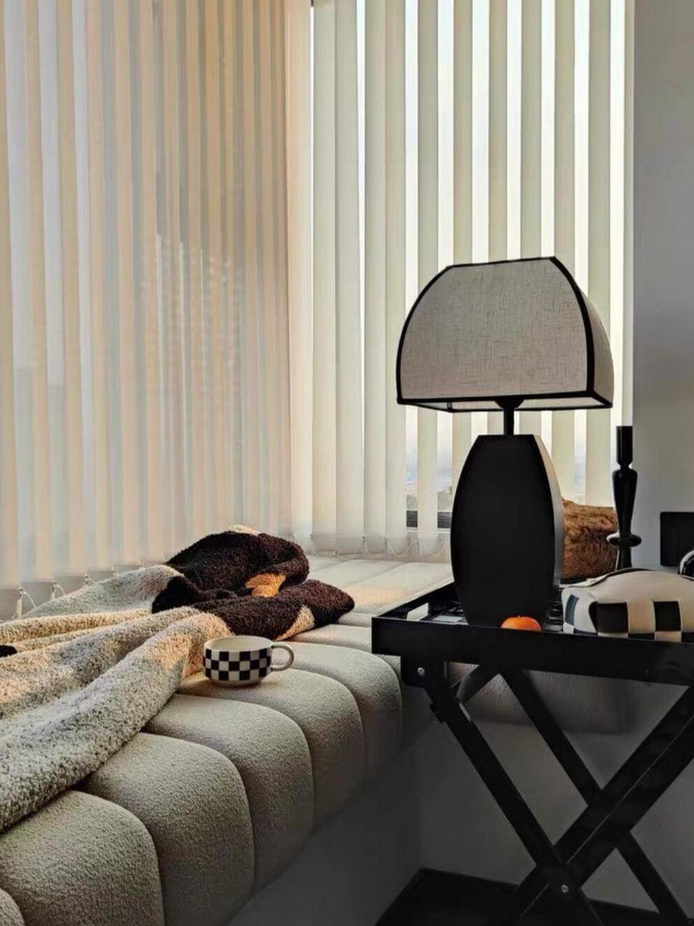 Javier lamp on black side table beside sofa