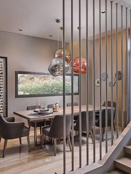 Pendant lighting seen through vertical room dividers