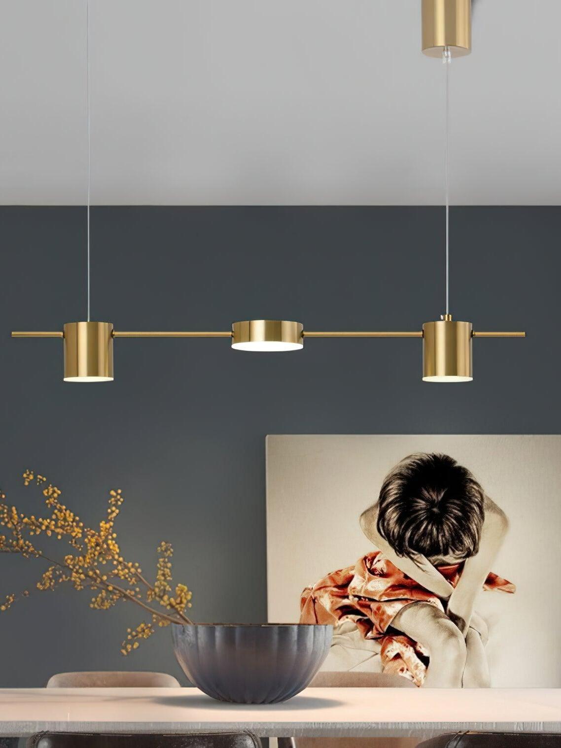 Short gold linear fixture above a table and artwork