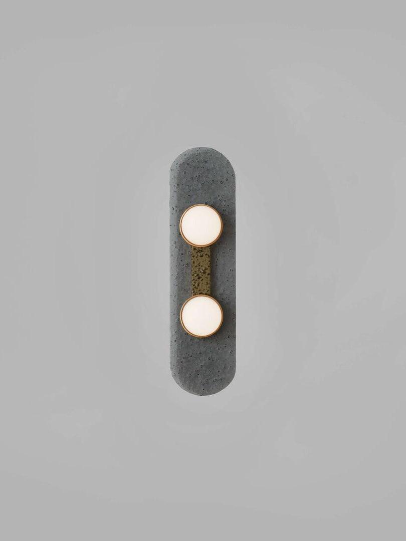 Front view of two glowing white Modulo domes on a rounded smoke-grey glass panel