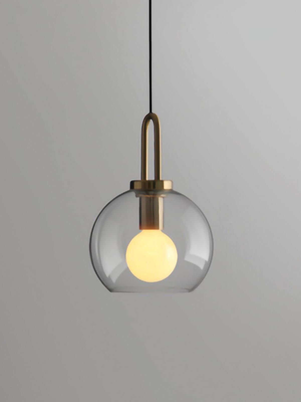 Small clear glass globe pendant with a metal top loop and visible bulb