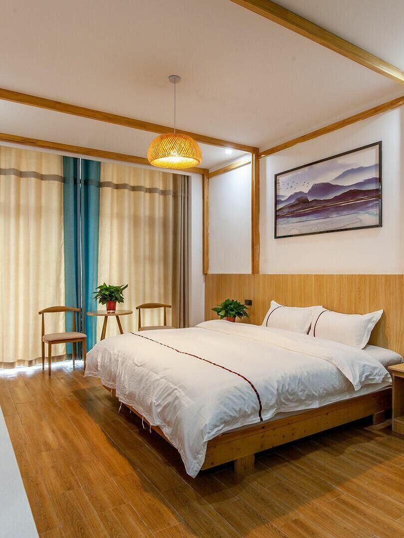 Lit bamboo shade in bedroom with timber floor