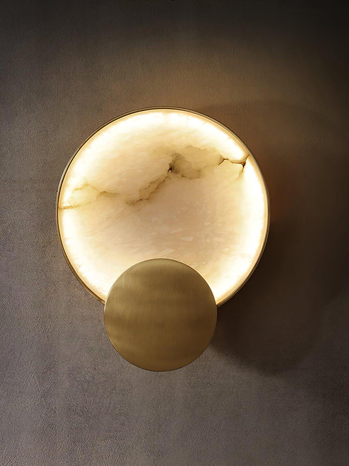 Glowing round stone wall light with lower Gold disk