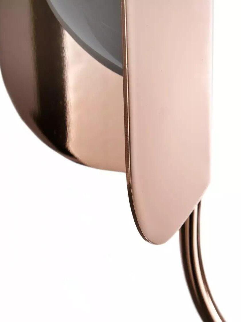 Curved edge of a rose-gold-coloured leaf shield