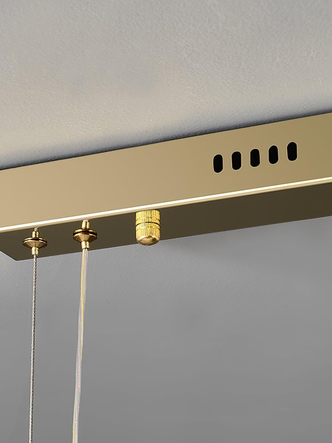 Close view of slots, cable attachments and a cylindrical fitting on the gold rectangular canopy
