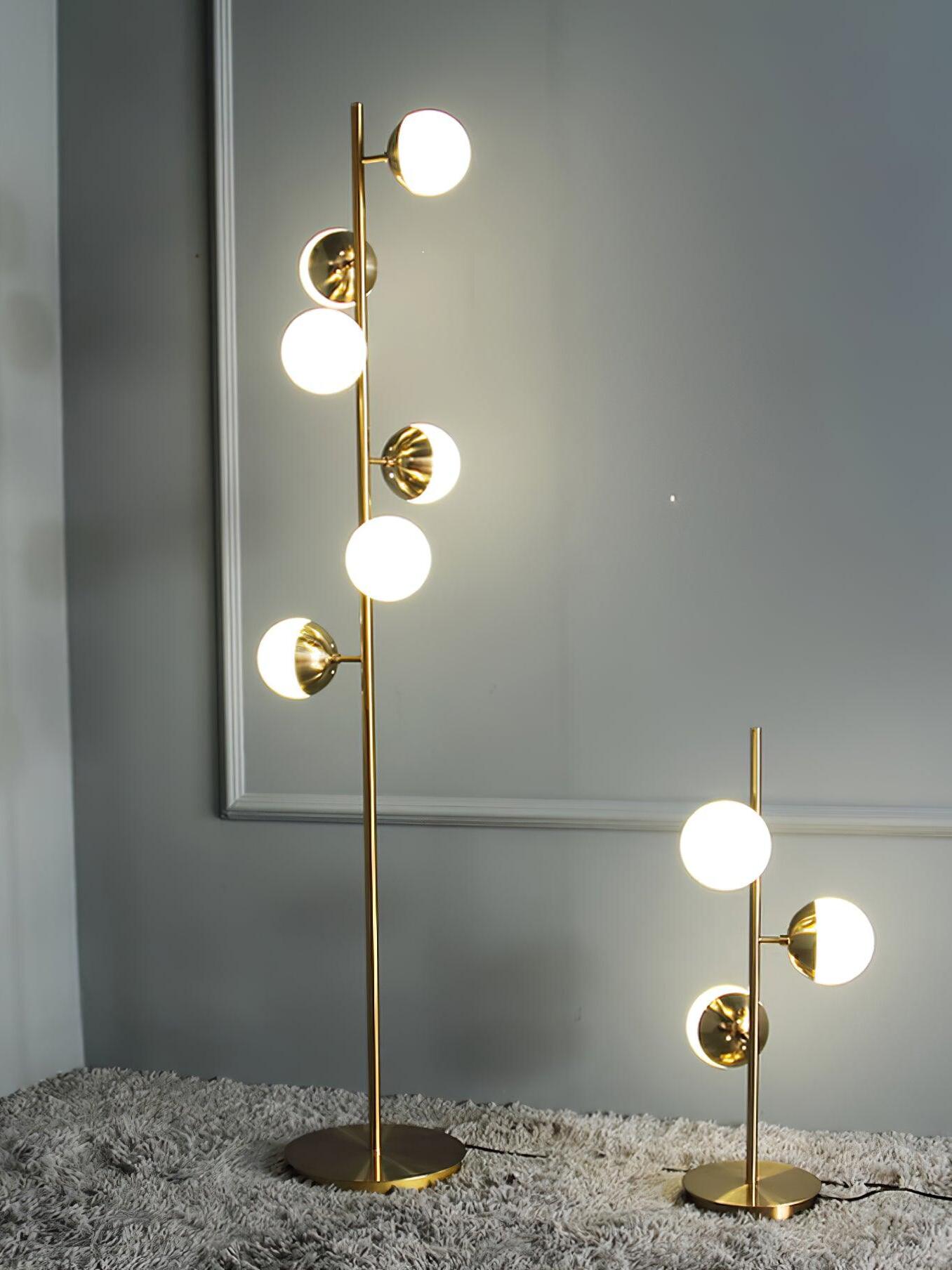 Tall and short gold globe lamps side by side