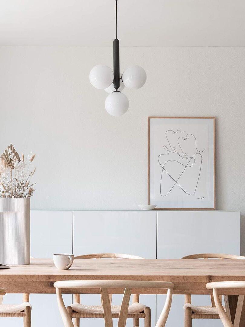 White globe cluster and black stem over a wood table