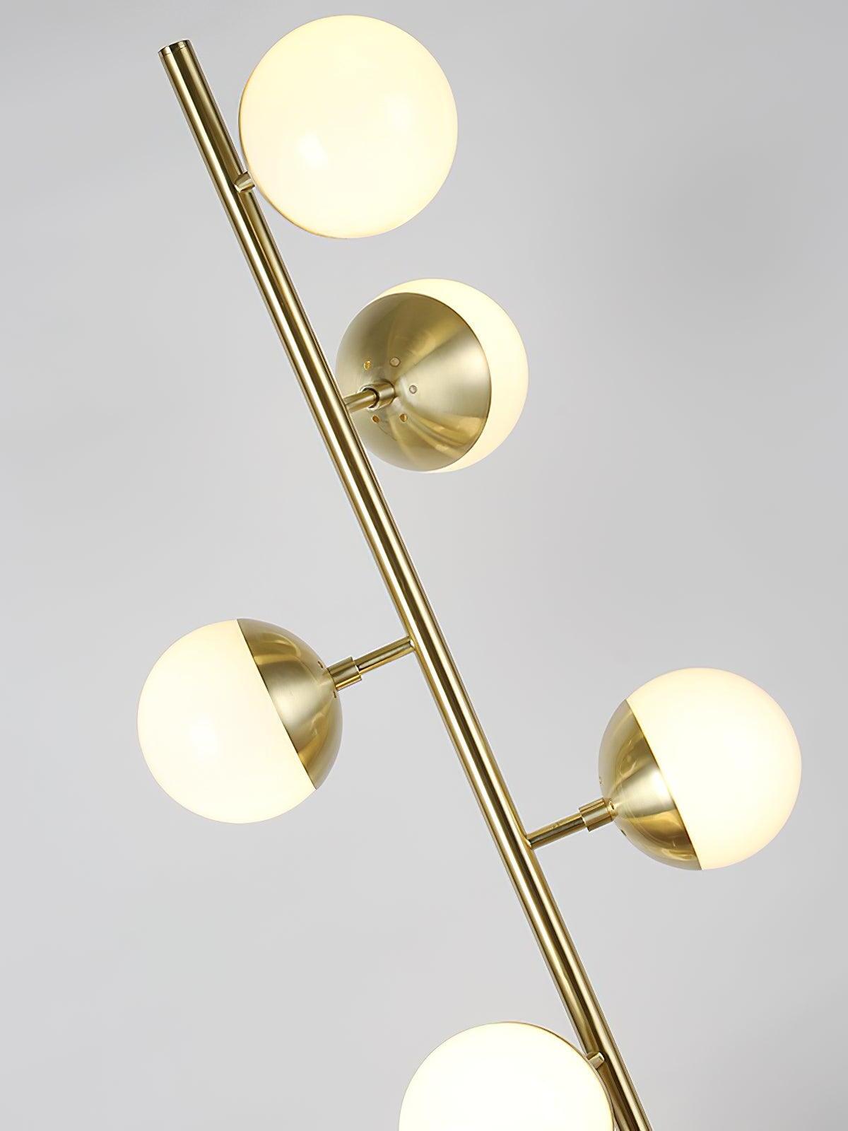 Angled close view of glowing globes on gold stem