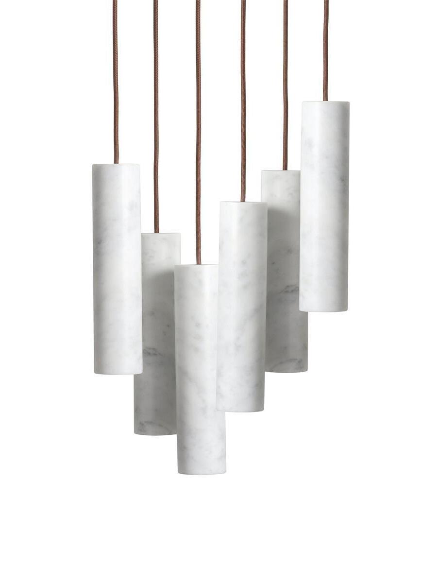 Six white Silo cylinders on individual brown cords arranged at staggered heights
