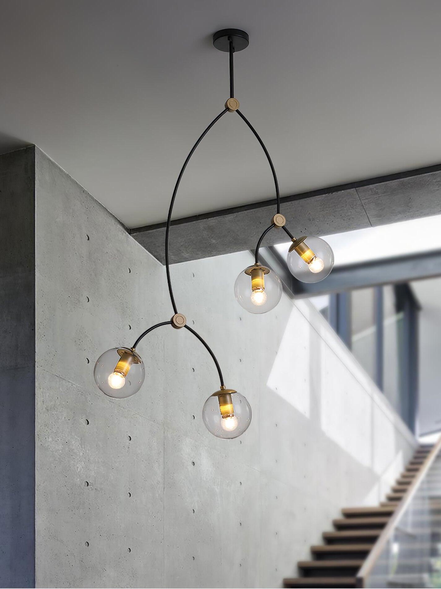 Four clear globes in a tall stairwell arrangement