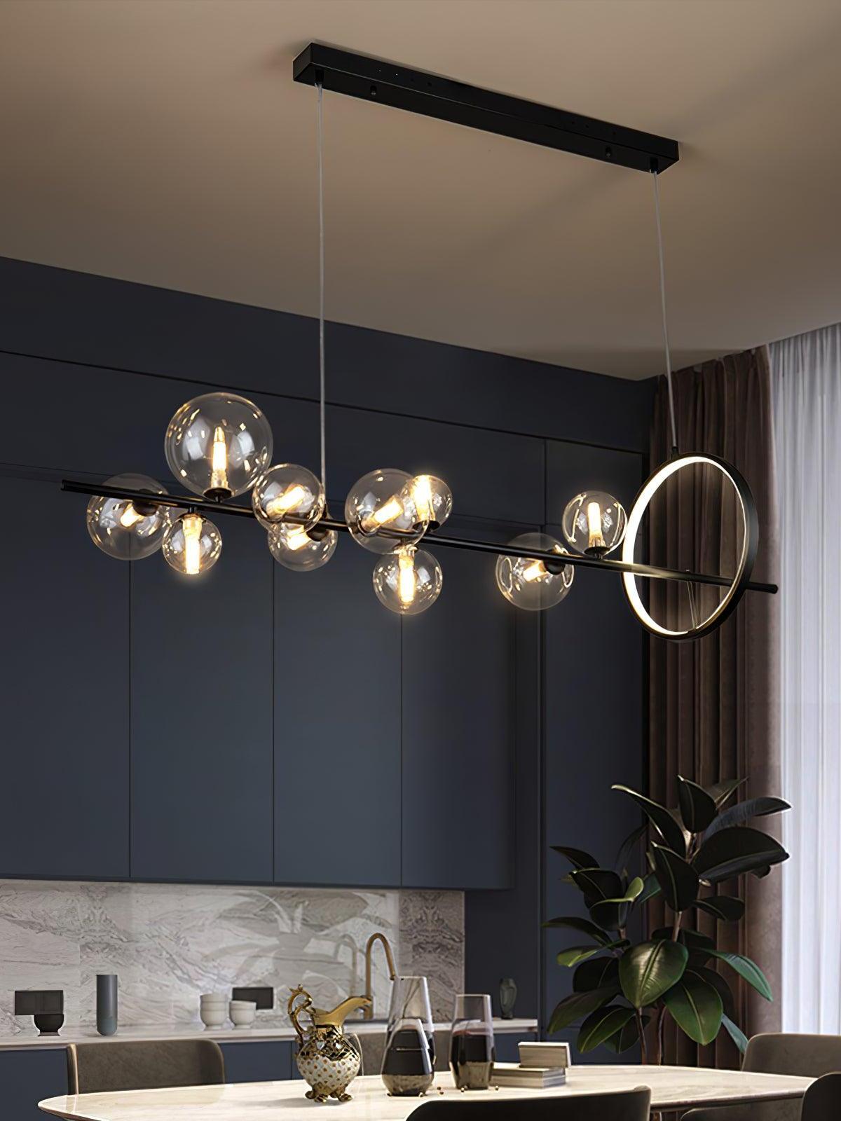 Lit globes and an upright ring above a dining area