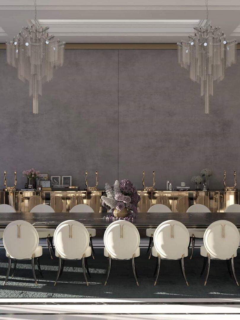 Two chain chandeliers above a large dining table