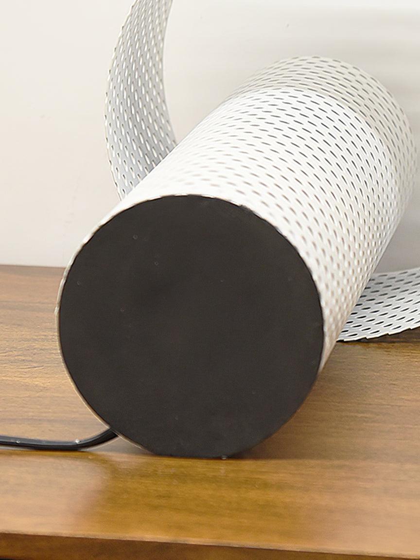 Underside of perforated table lamp with dark circular pad