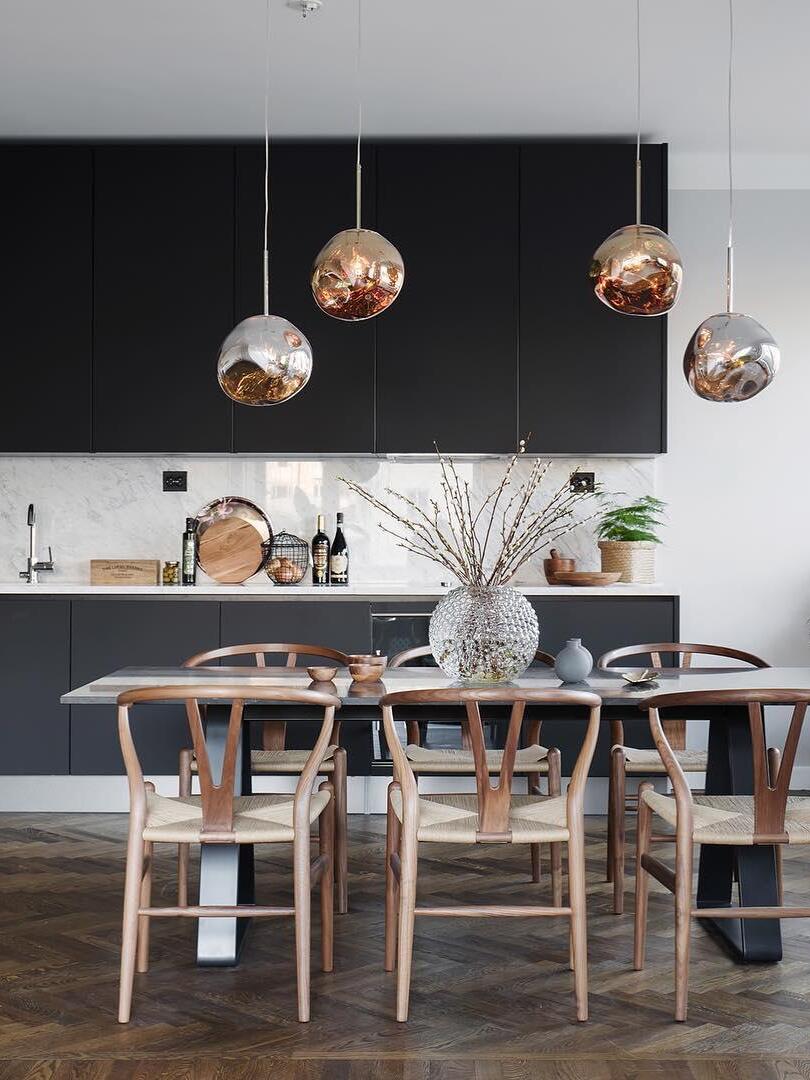 Metallic-looking pendants in an open dining area