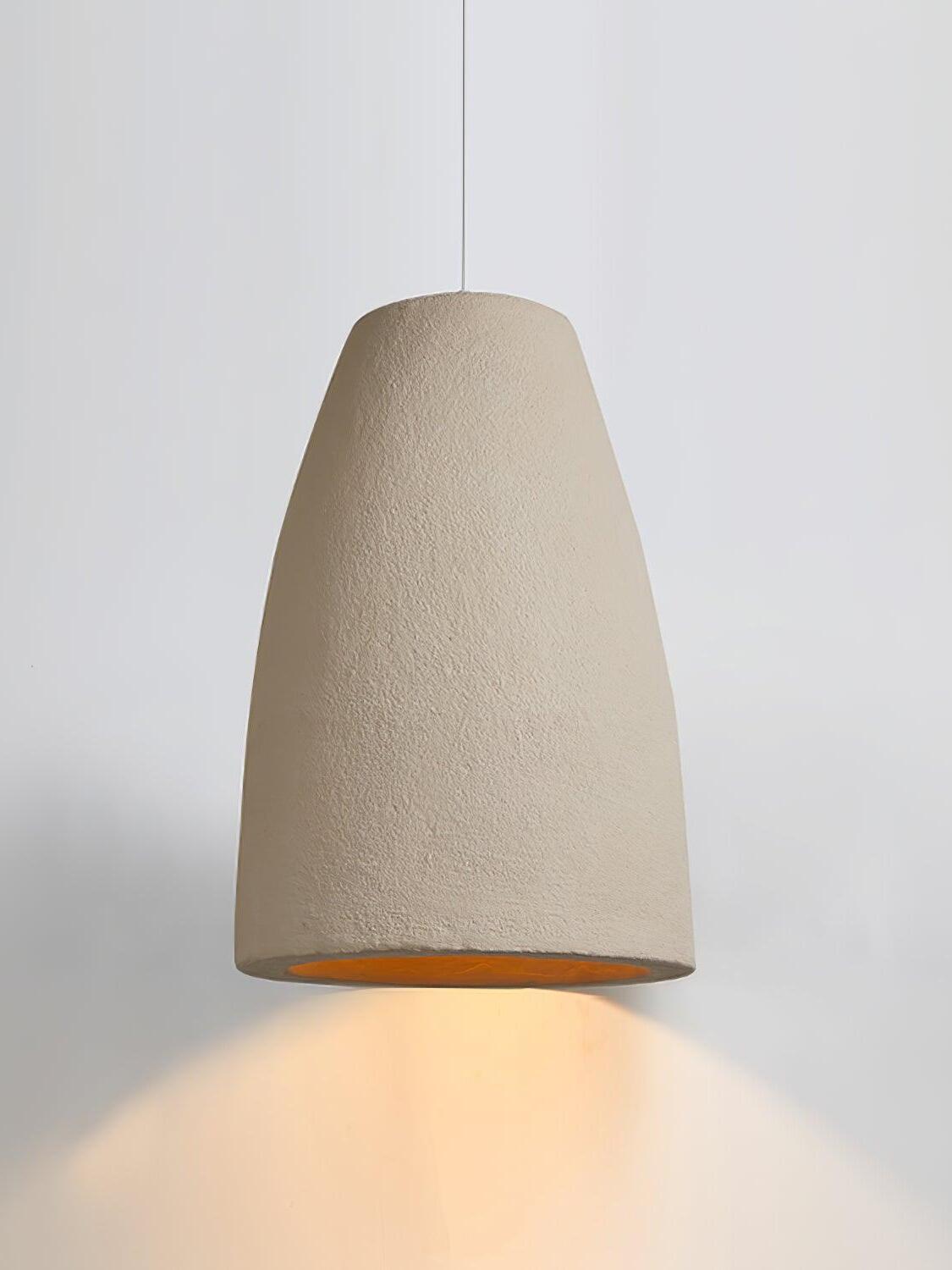 Broad tapered pendant shade with a rough pale surface, thin cord and light glowing below on white