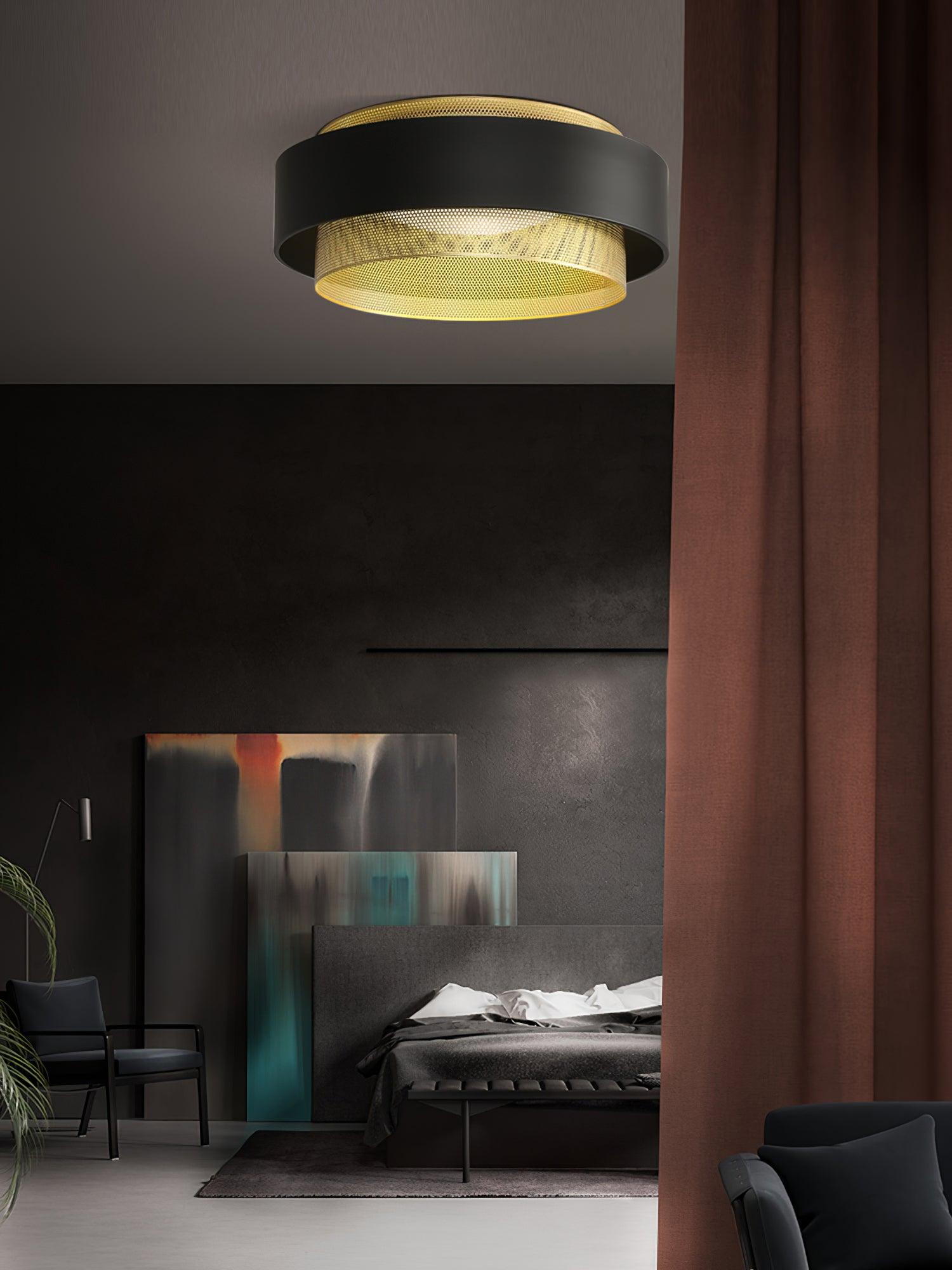 Black and gold Nolan ceiling light in a dark seating room beside a curtain