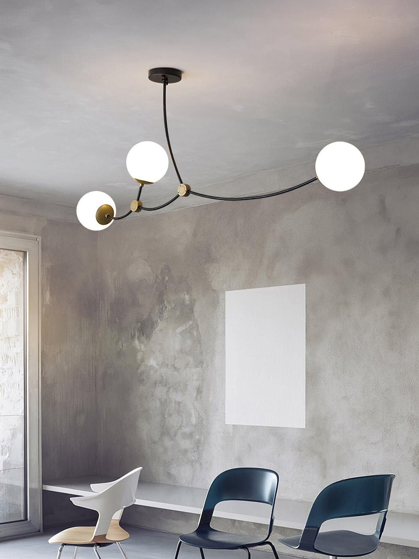 Three white globes above blue dining chairs
