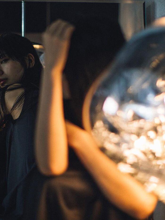 Close scene of a person beside a bright pendant