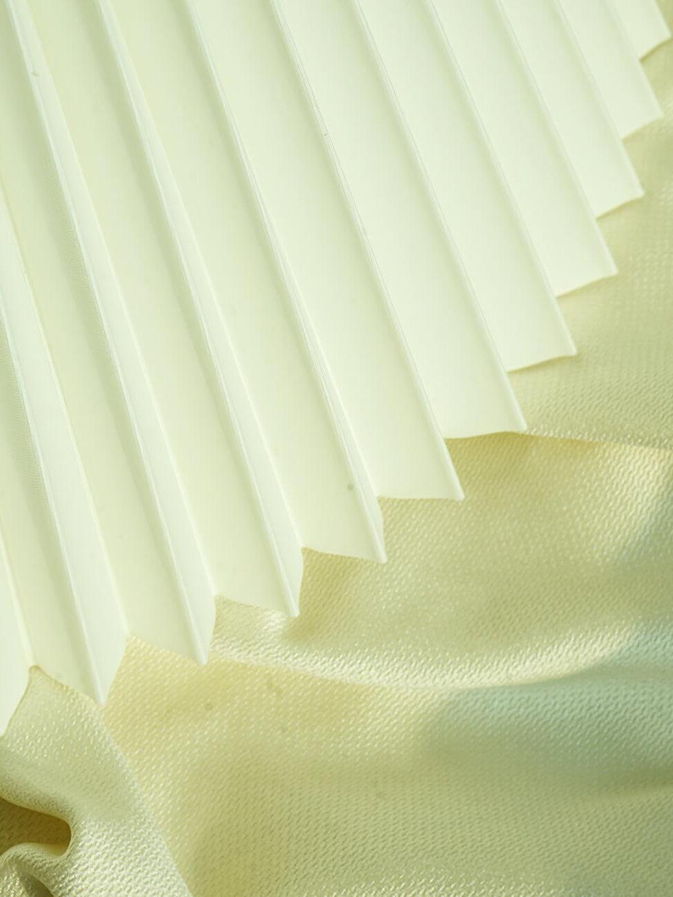 Close view of plain white pleated shade edge