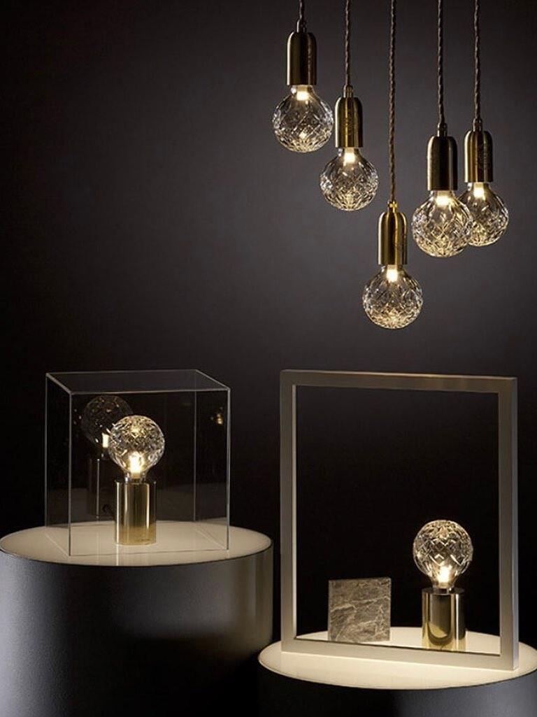 Styled hanging globe lights above tables with small globe lamps