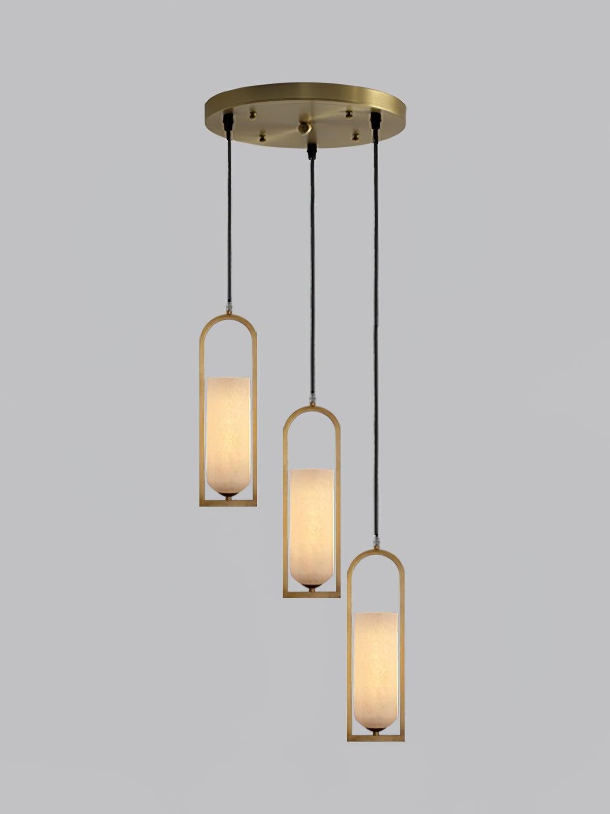 Three glowing Melange pendants suspended at staggered heights from a round brass-coloured canopy