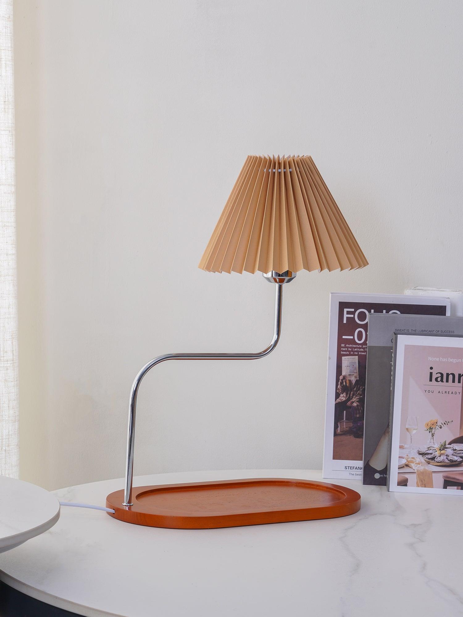 Brown pleated shade on curved metal stem over long tray