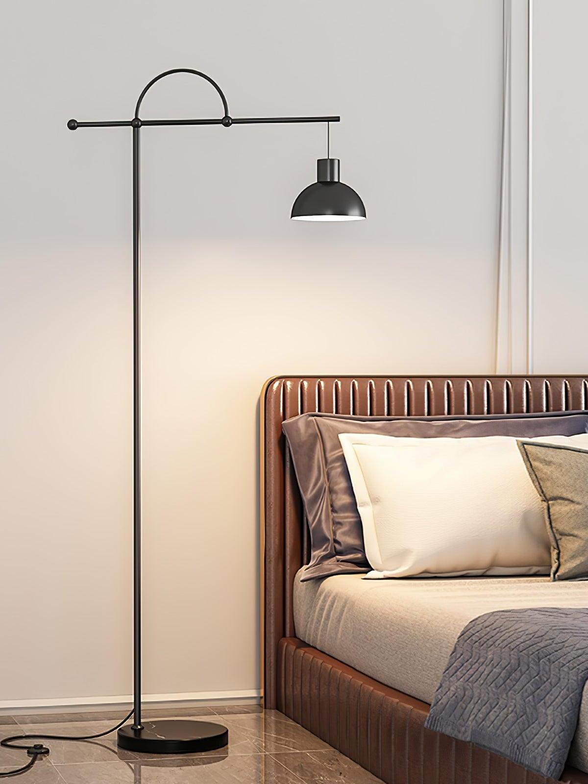 Nidal black bell-shade floor lamp beside a bed