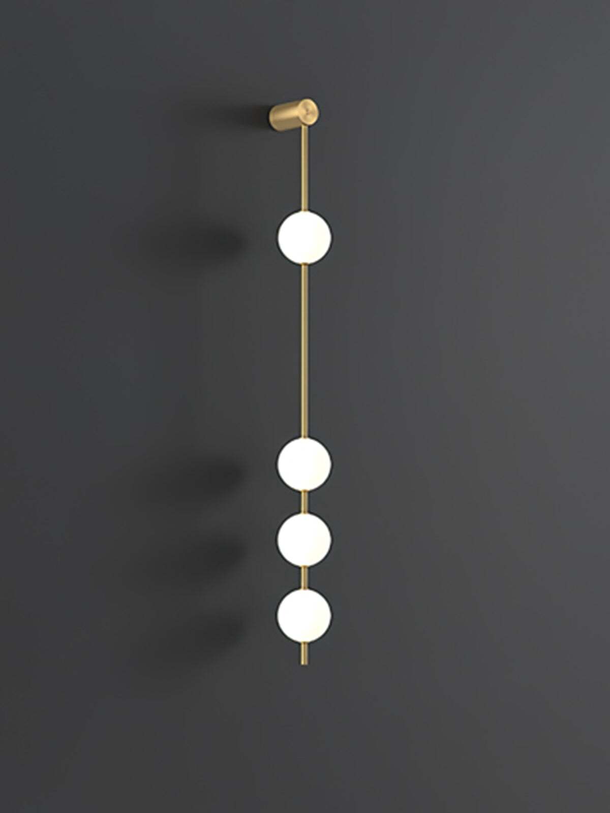 Enlarged four-globe wall lamp with lit white spheres on a gold-colour rod against dark grey