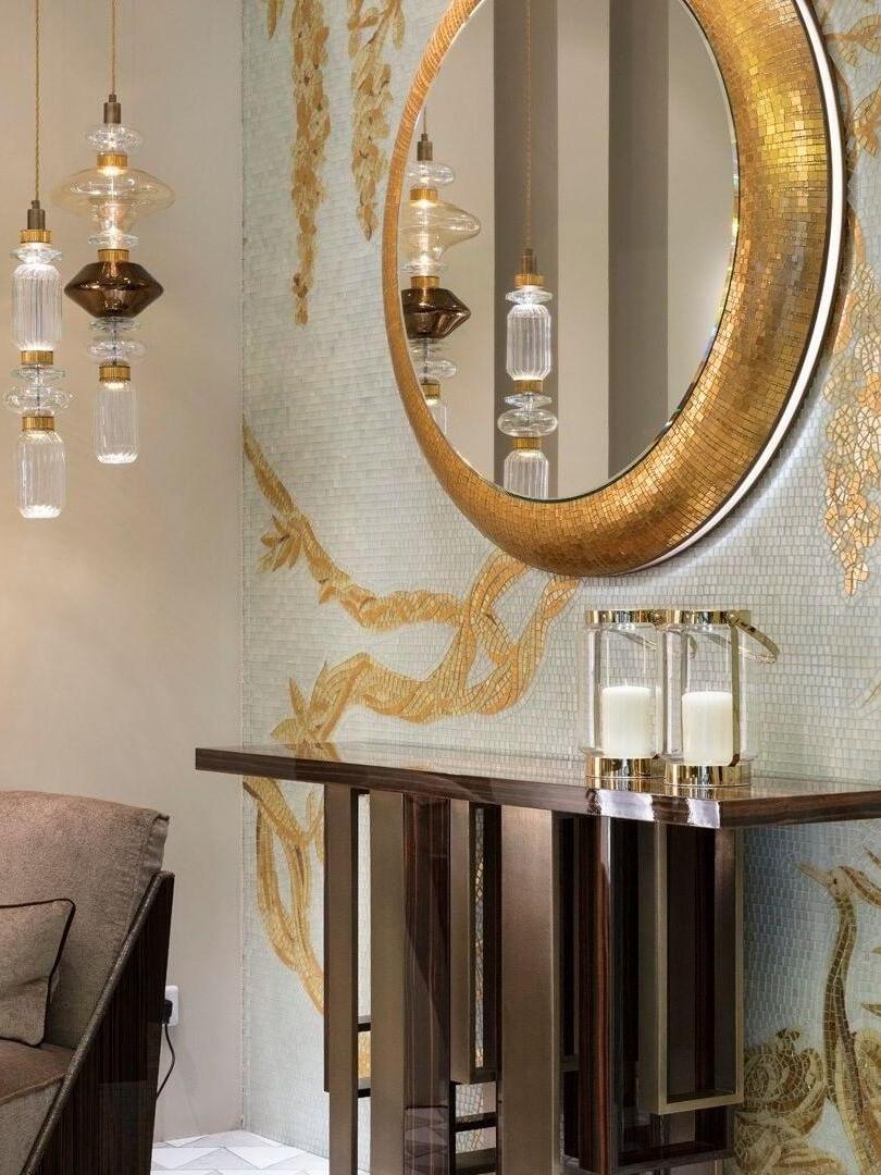 Glass pendant grouping beside a large round mirror