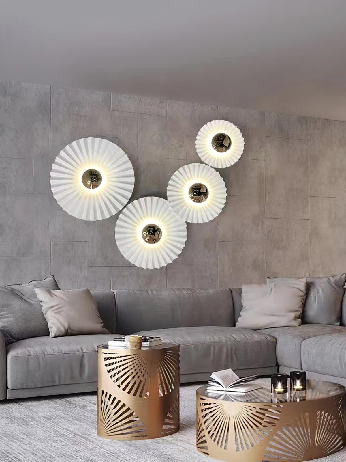 White gold pleated wall lights over grey sectional