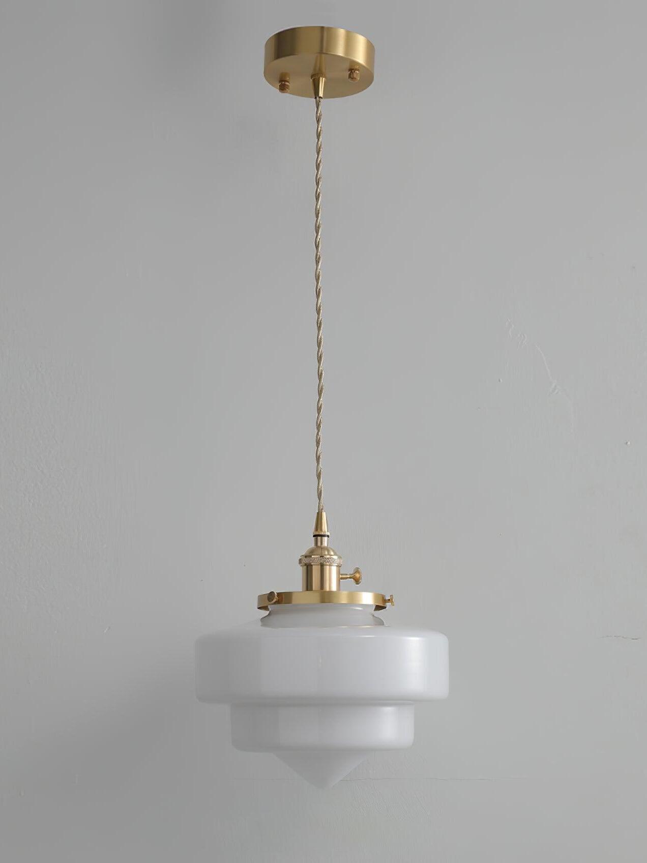 Whole Atlas Model A single pendant against gray, with round brass canopy, stepped white glass shade and pointed tip
