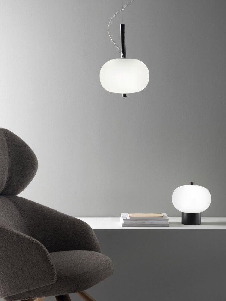 Single globe pendant pictured with a separate table lamp