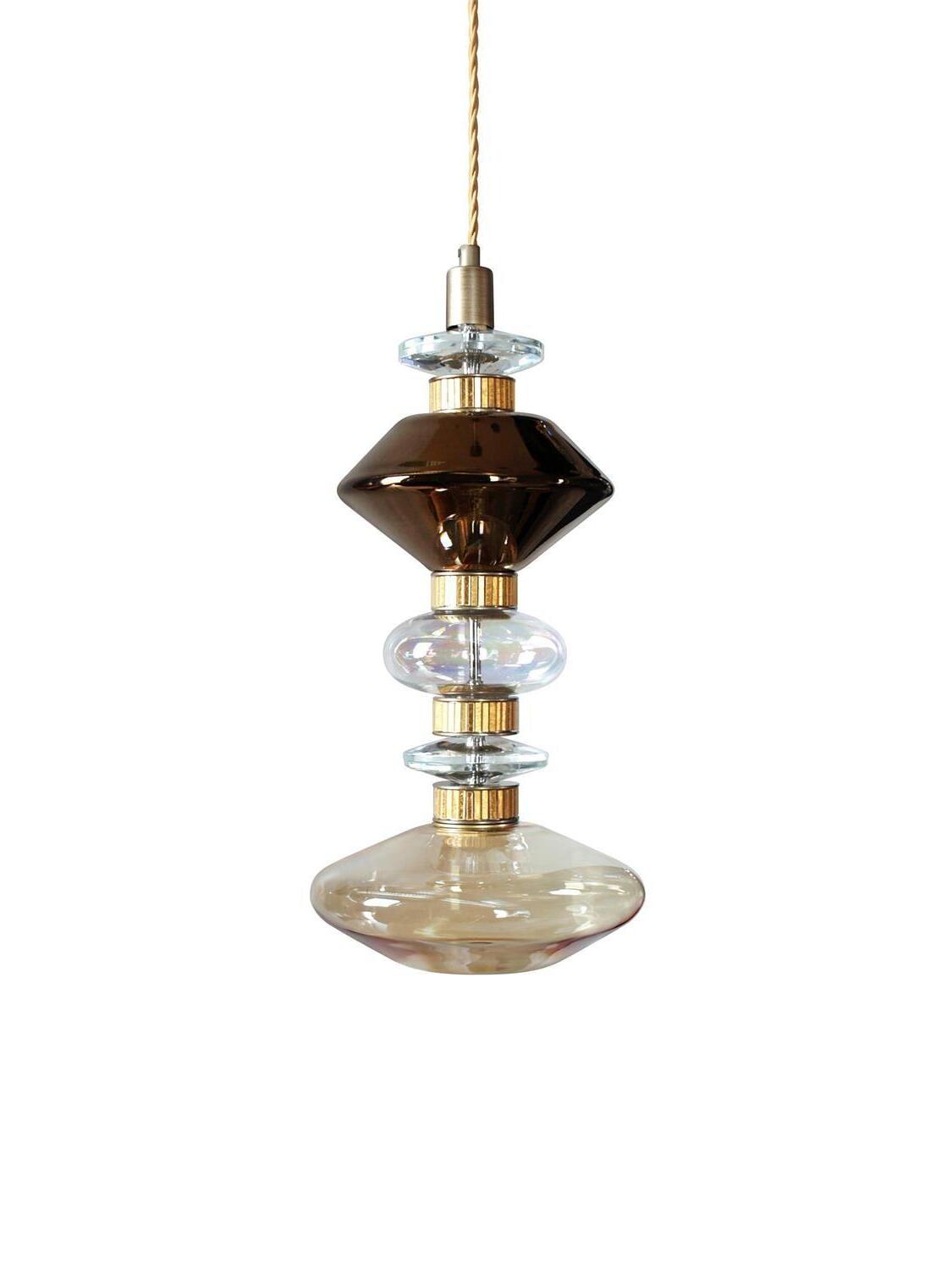 Dark angular glass between clear rings and amber lower disc
