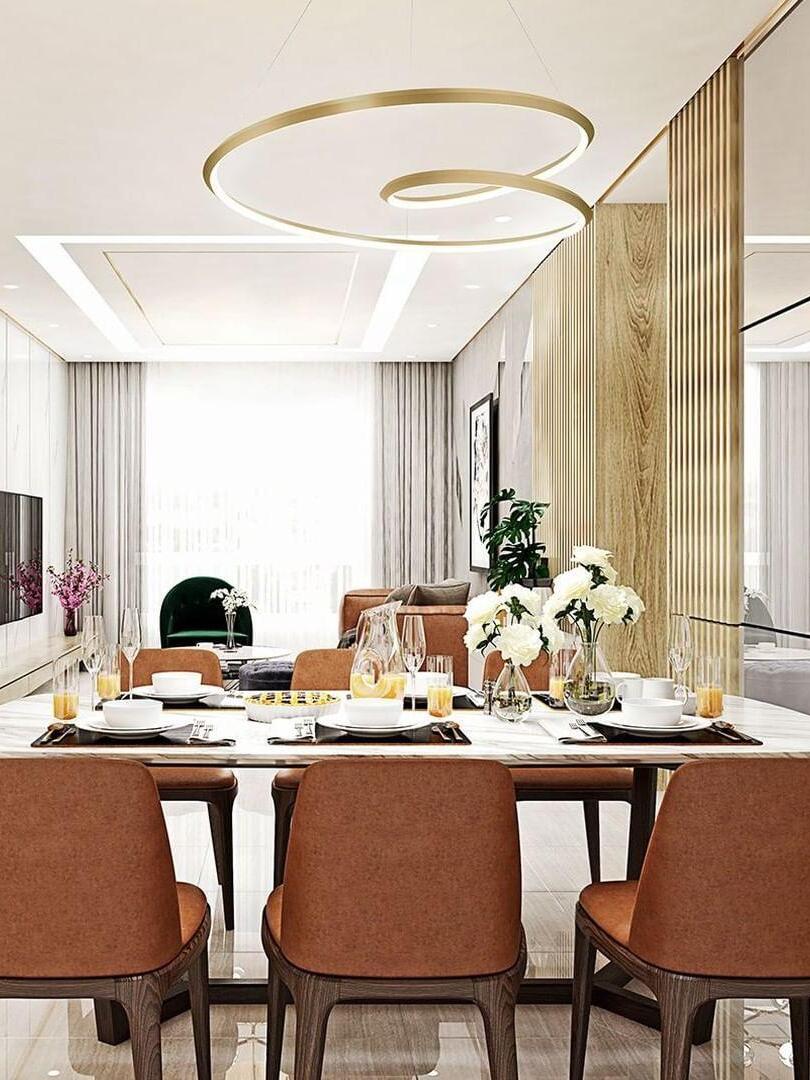 Gold looping chandelier over an indoor dining table