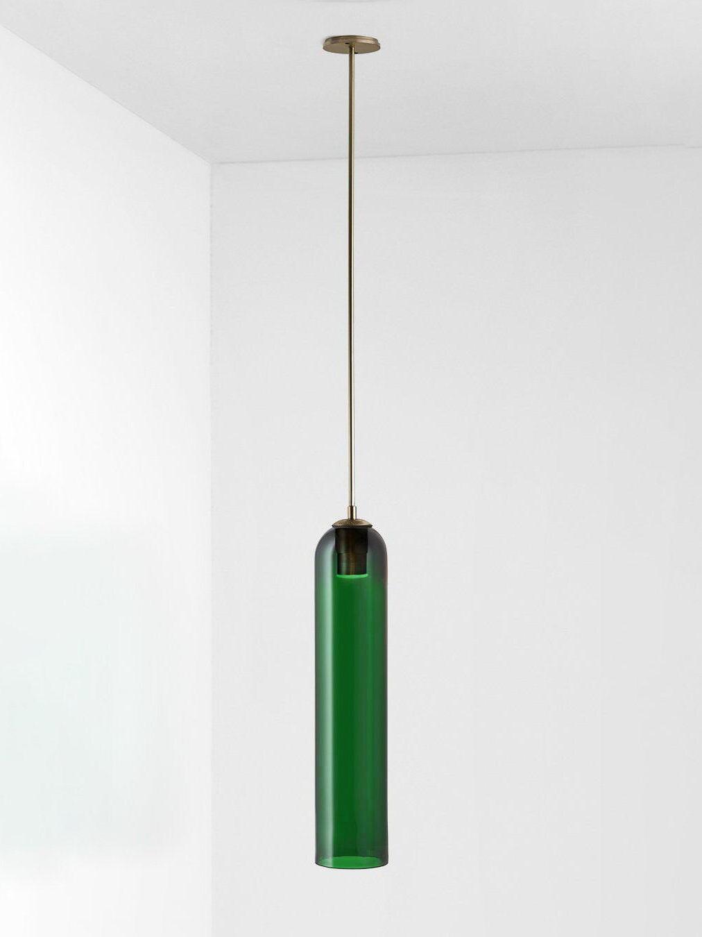 Green glass Long Tube pendant with gold-toned straight rod and round ceiling canopy on pale background