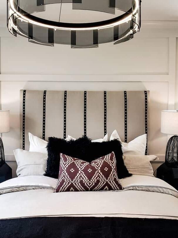 Glass ring chandelier above a patterned bed