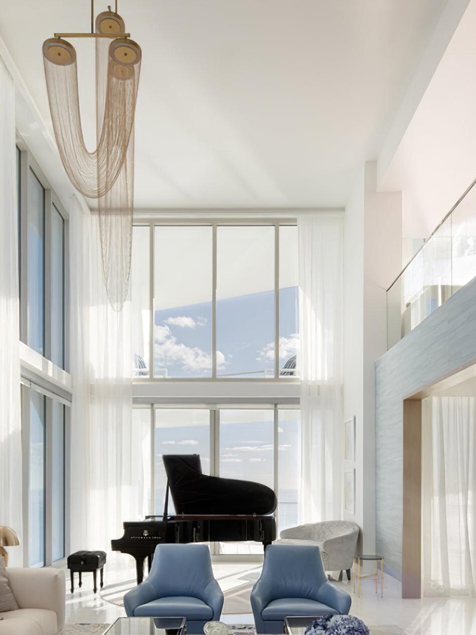 Tall chain lighting in a double-height living room