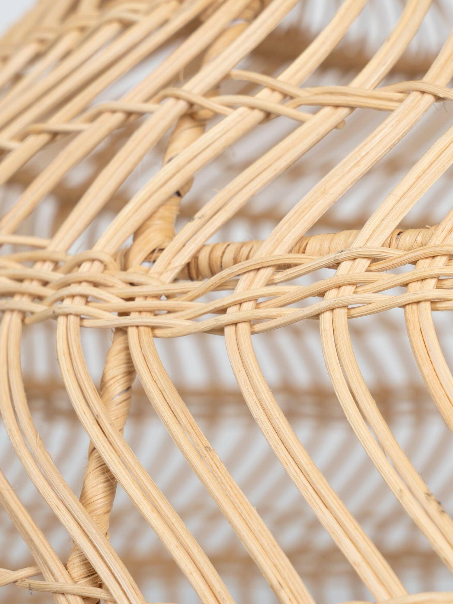 Natural rattan strips tied across curved ribs