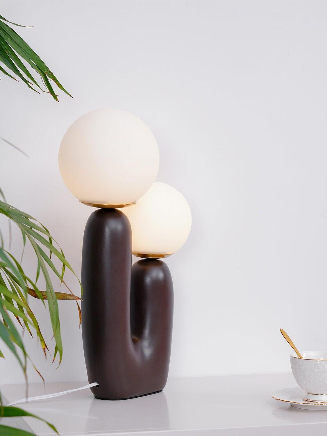 Close view of dark body and two opal globes