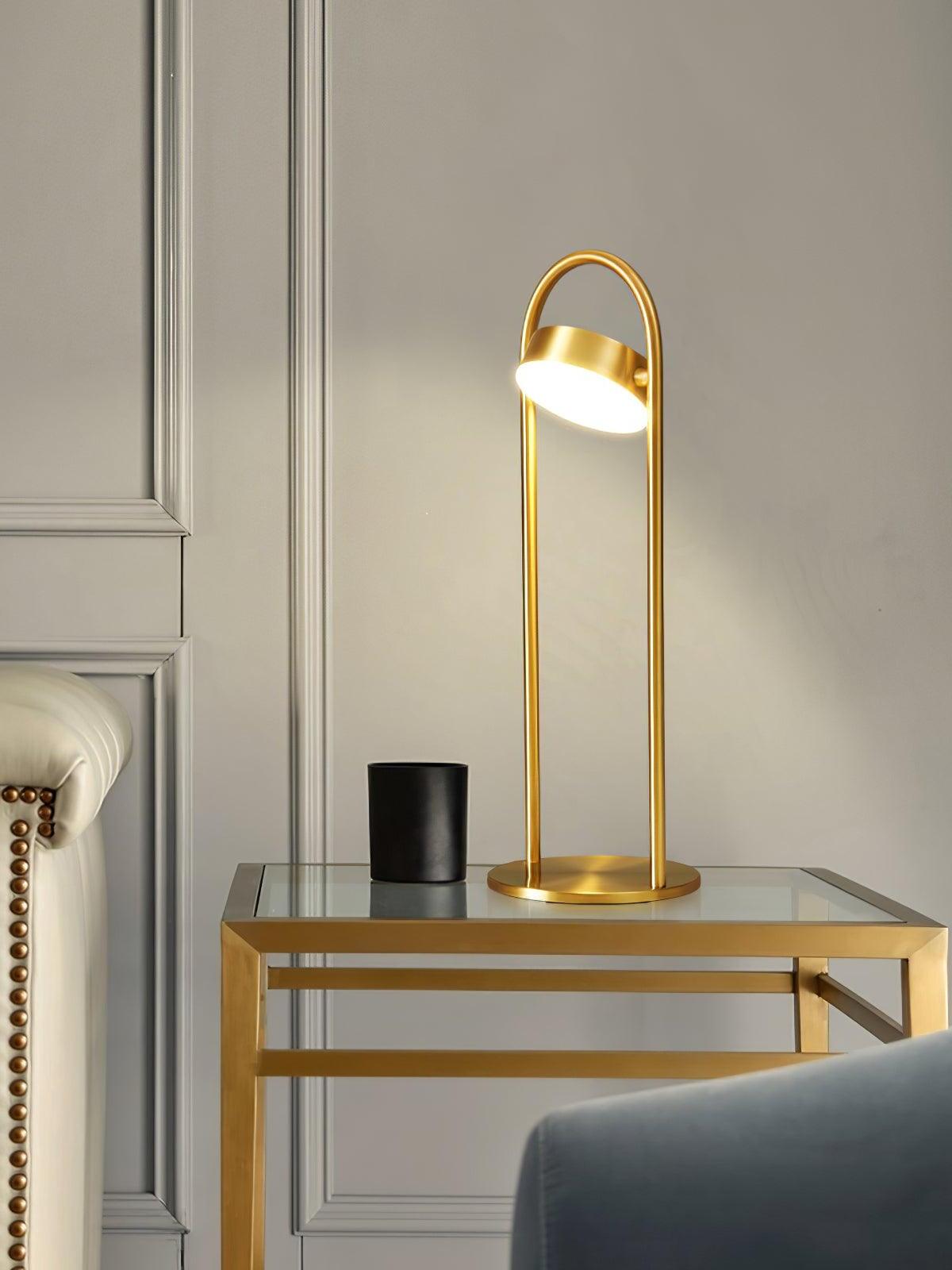 Upright brass LED lamp on glass-top side table