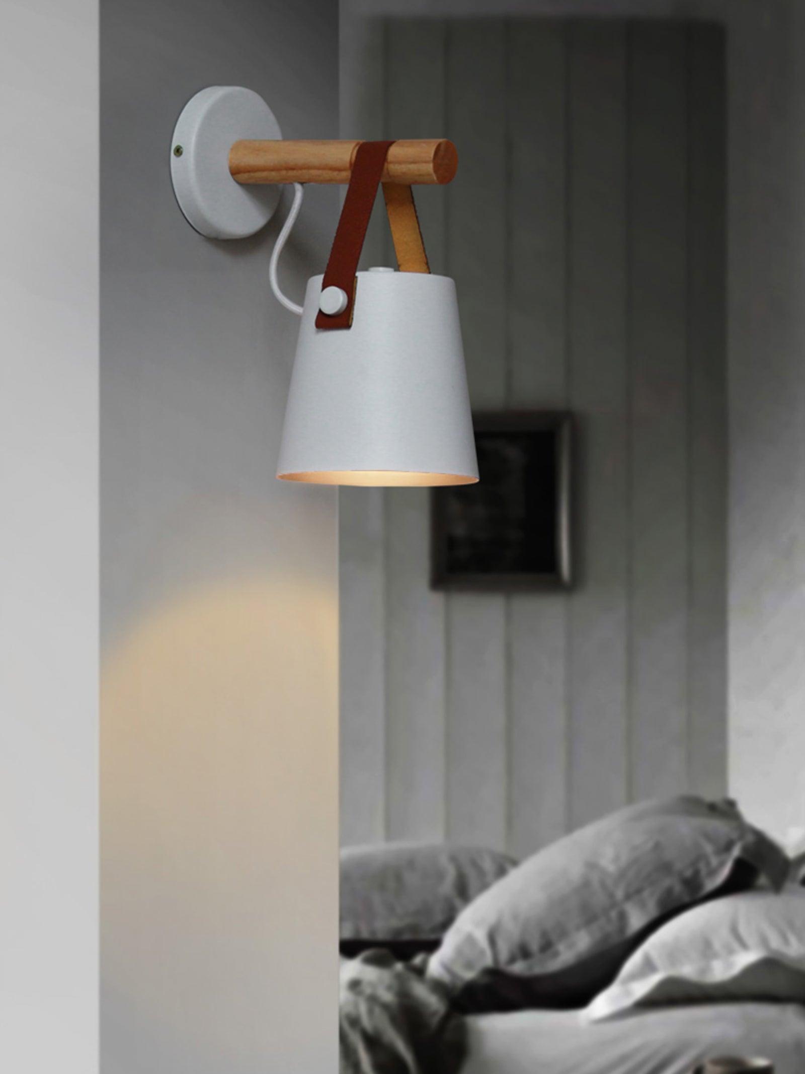 Lit White hanging wall shade beside a bed