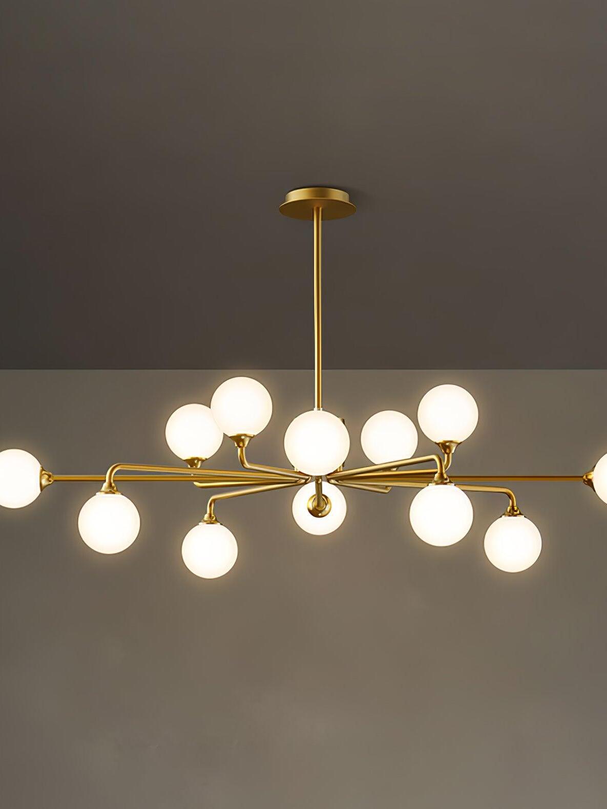 Middle-width brass chandelier with white glass globes