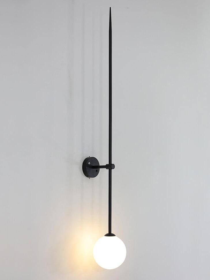Lit black linear wall light at an angle, with one white globe below the round backplate
