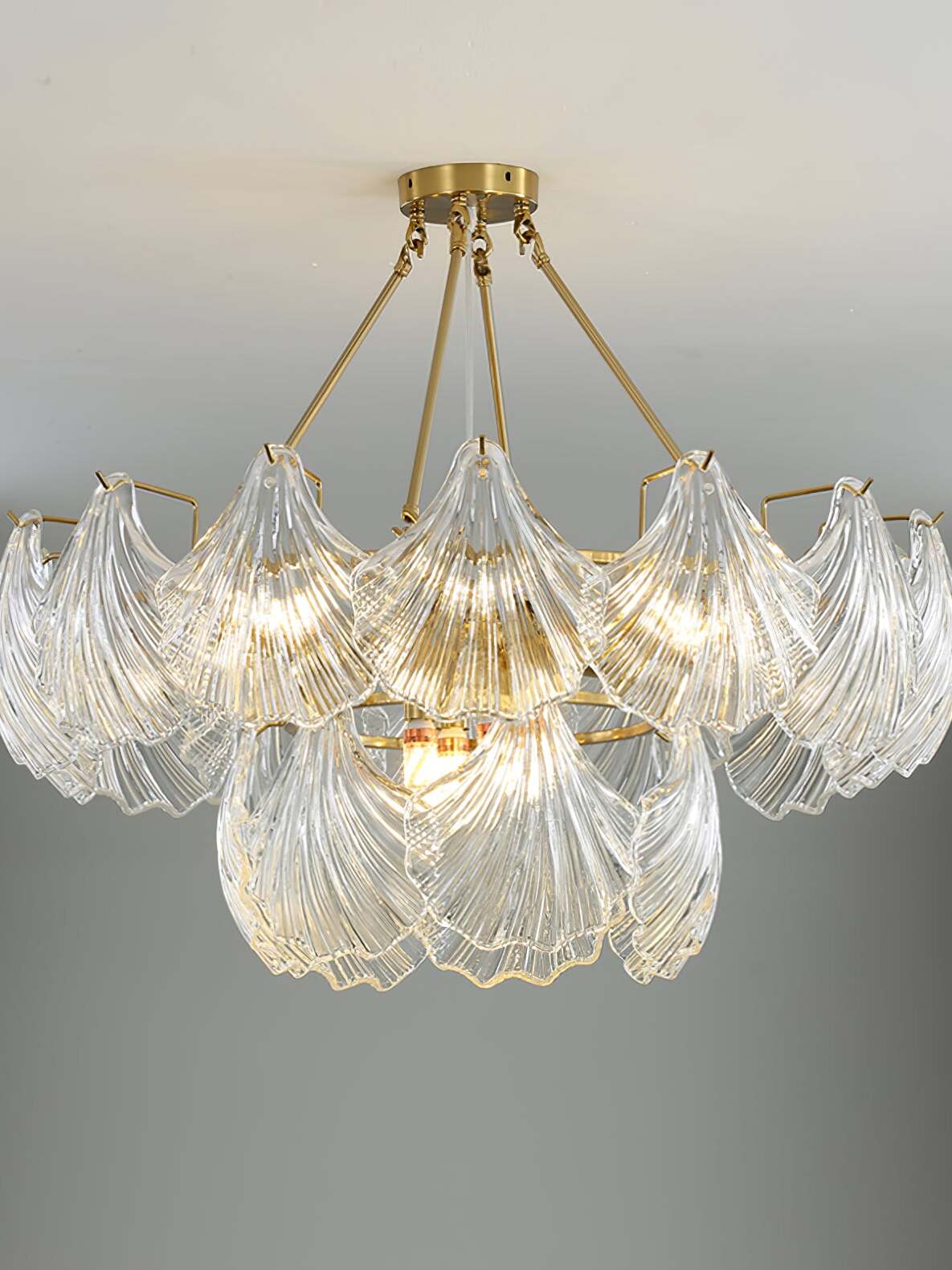 Broad round Ribbed Shell fixture with upper and lower glass tiers suspended on gold-tone rods