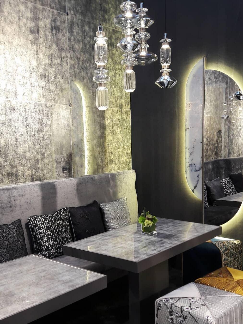 Several glass pendants above grey seating booth