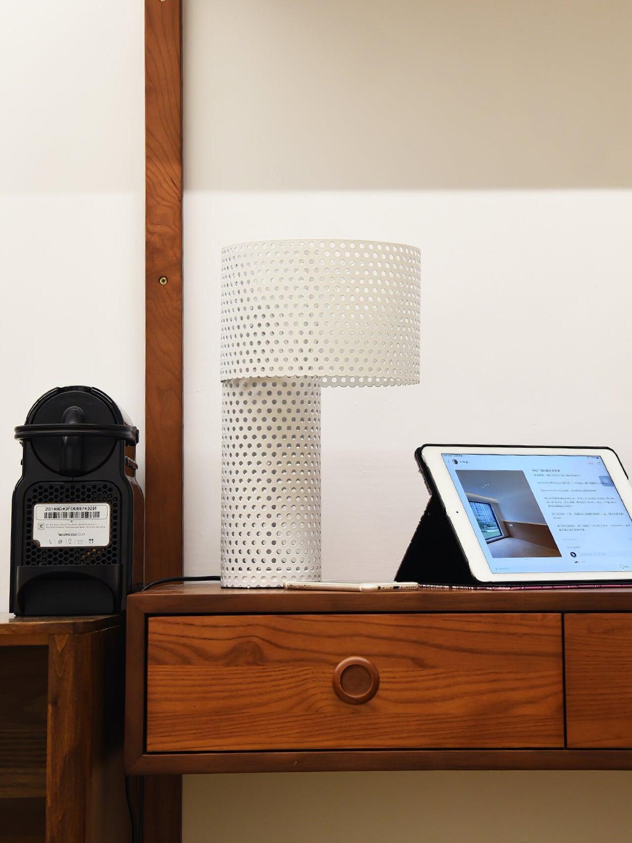 White perforated lamp on cabinet near tablet
