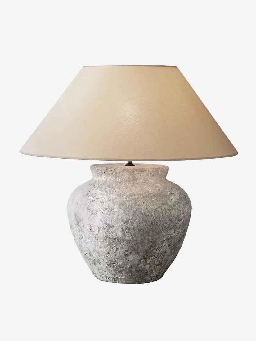 Weathered white ceramic urn table lamp on white background